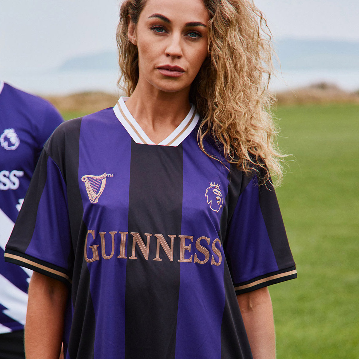 Purple and black striped Guinness Premier League football top with crest and large GUINNESS lettering