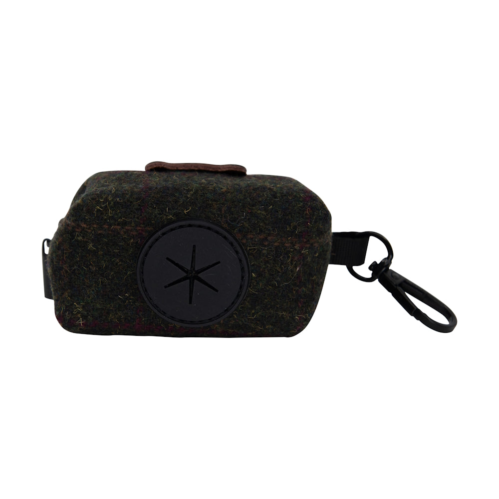 Dark tweed poo bag holder with a circular black logo patch and attached clip