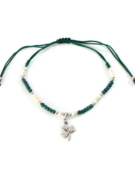 Adjustable green string bracelet with white and green beads and clover charm