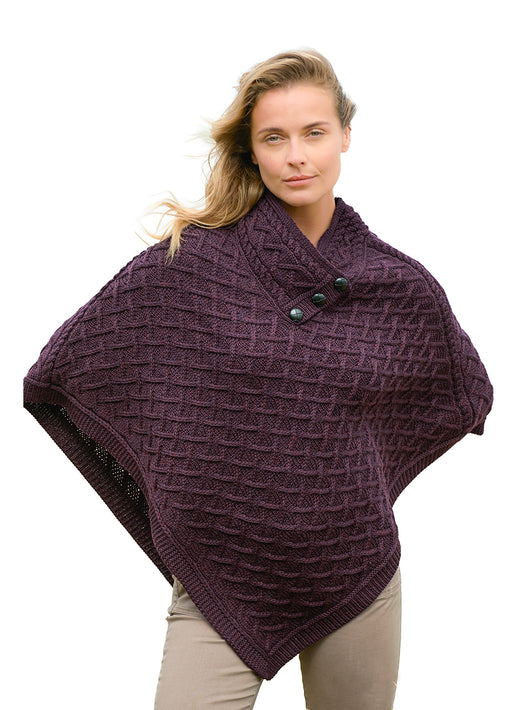 Plum merino poncho with lattice knit and buttoned collar worn by a model