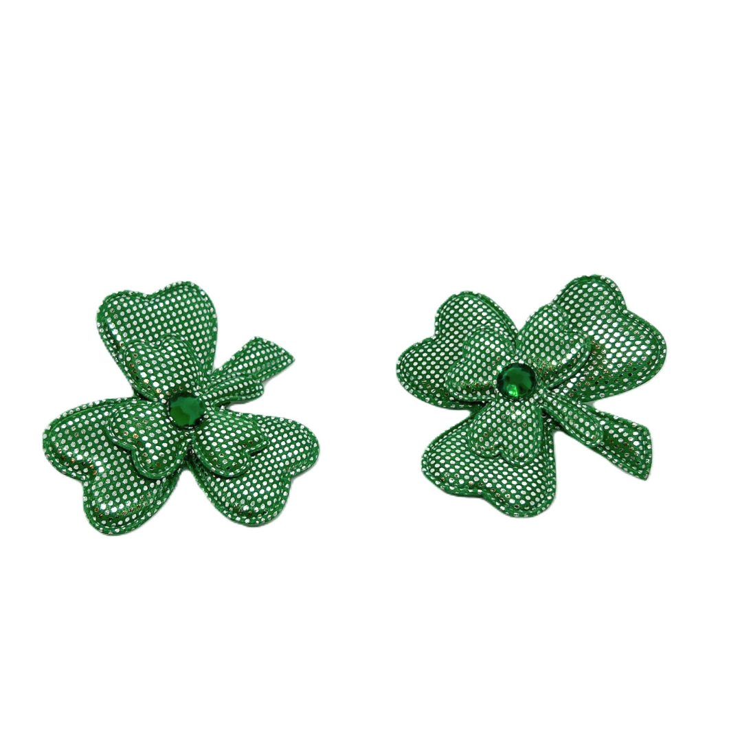 Two green fabric shamrocks with white polka dots and green gem centers