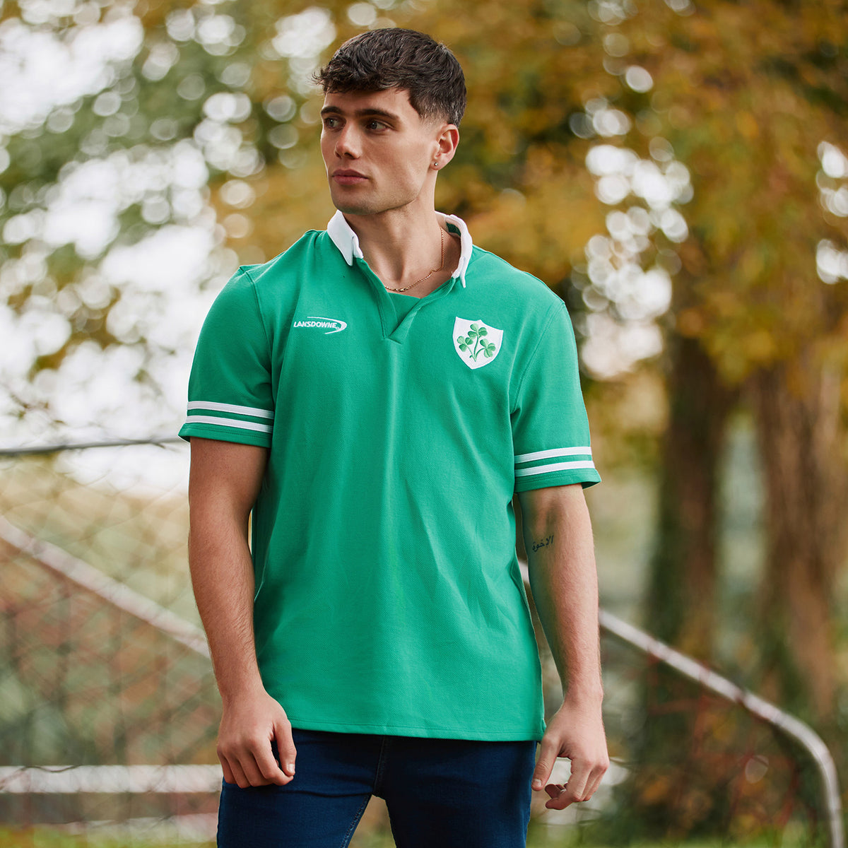 Male model wearing green Landsdowne Ireland Shamrock polo with white collar and shamrock crest on chest