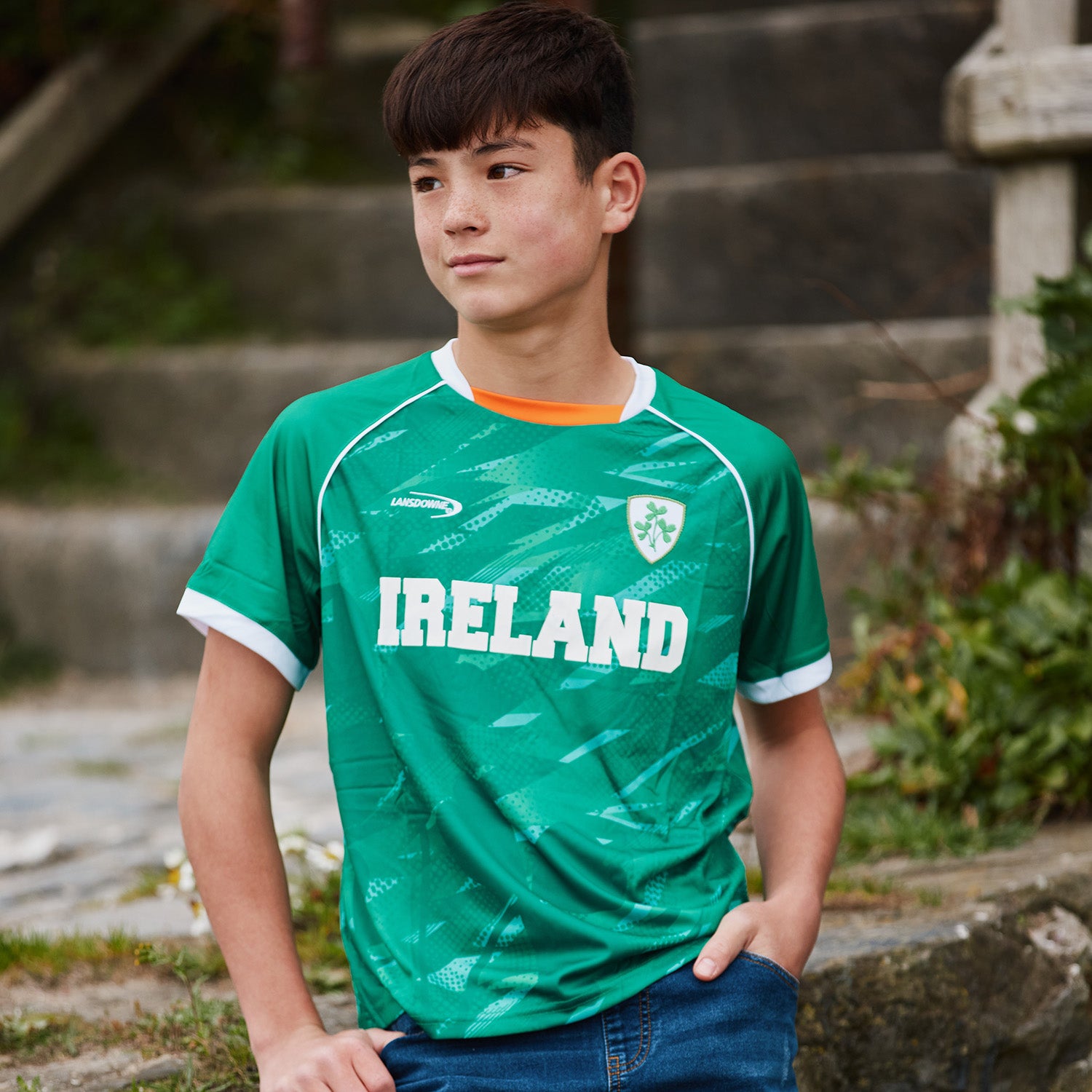Young boy wearing a green Ireland shamrock performance T shirt outdoors