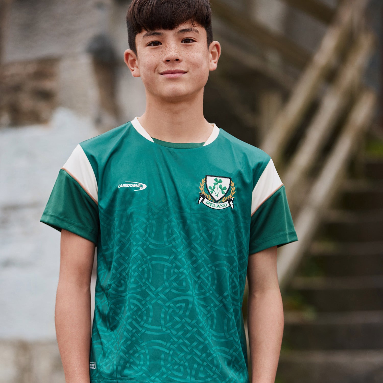 Young boy wearing a green Lansdowne Ireland Celtic sublimated performance T shirt with a crest on the chest