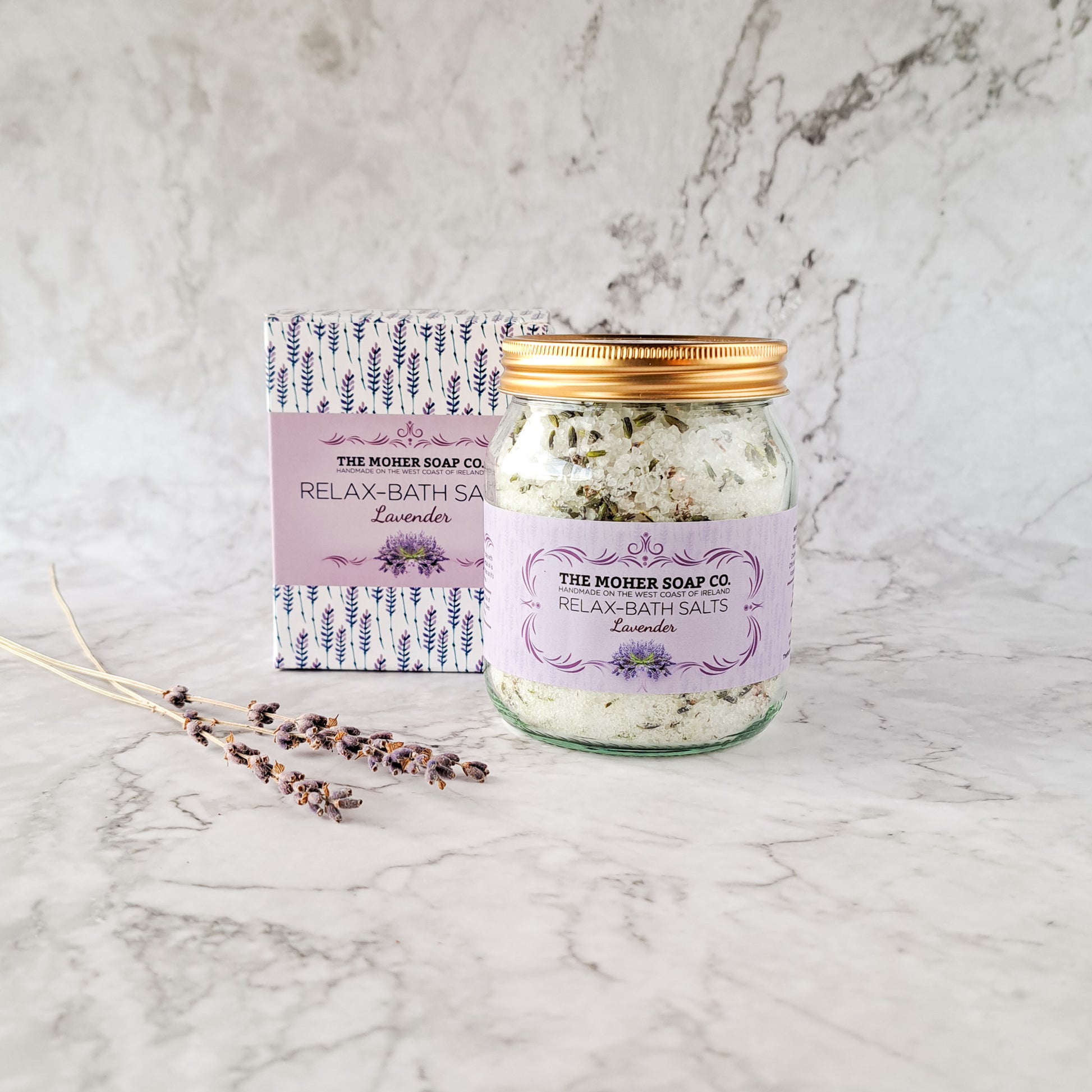 Lavender Relax Bath Salts 320g in a jar with copper lid beside a patterned box.