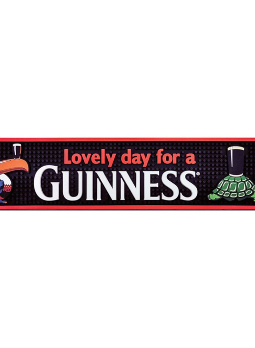 Guinness PVC bar mat with red border showing the phrase Lovely day for a Guinness and cartoon toucan and turtle