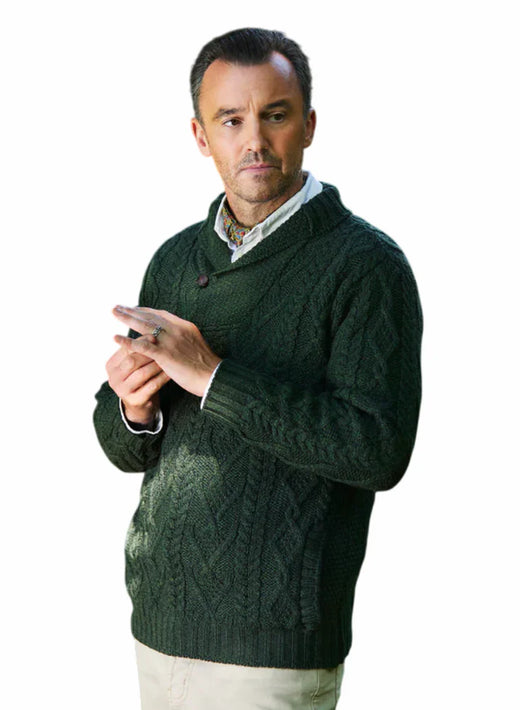 Man wearing a dark green shawl collar Aran cable knit sweater