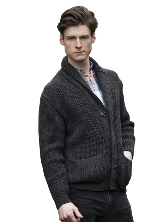 Male model wearing charcoal Aran knit cardigan with shawl collar and front pockets.
