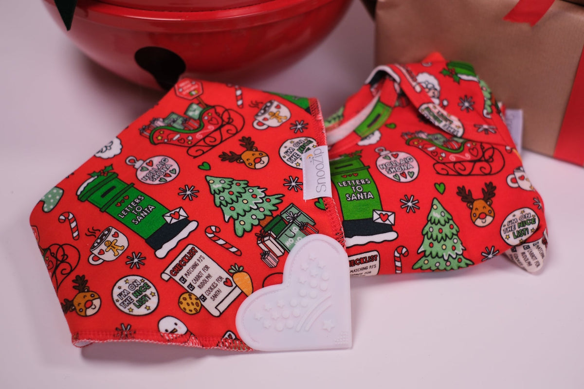 Red Signature Christmas Teething Bib displayed with attached white heart shaped silicone teether