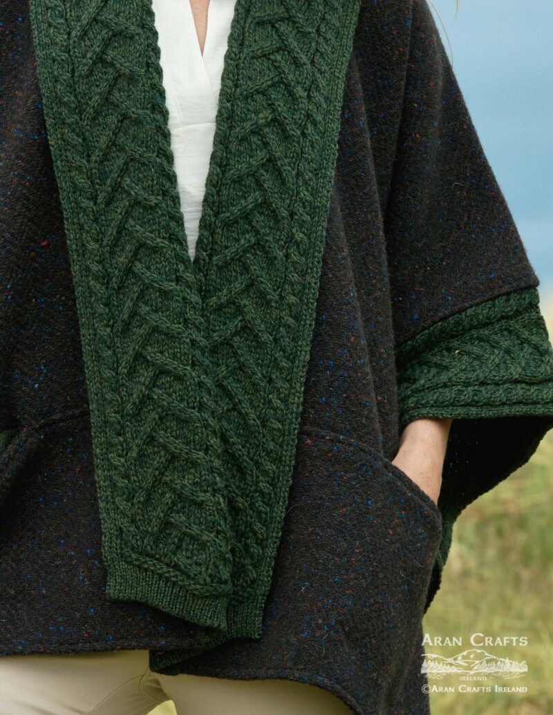 Close up of green cable knit trim and cuffs on navy Donegal cape