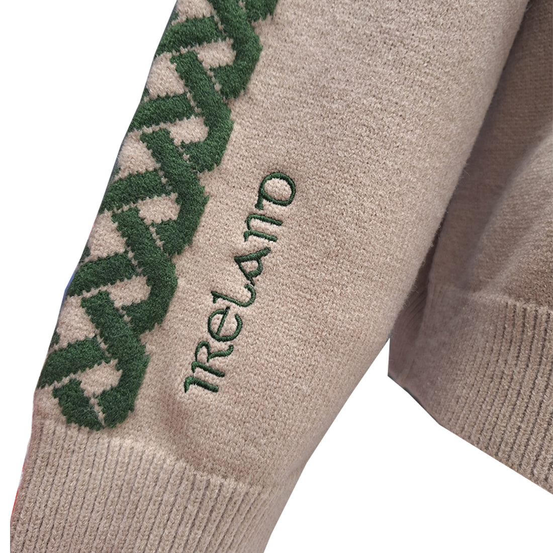 Beige sleeve with green Ireland lettering embroidered along its length on the Celtic Knot Stone Crew Neck sweater