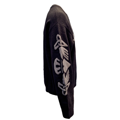 Side view of a black and grey sweater with a white Celtic knot pattern on the sleeve