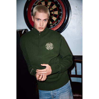 Model wearing sage green Celtic Knot 1/4 zip sweater with a white embroidered logo