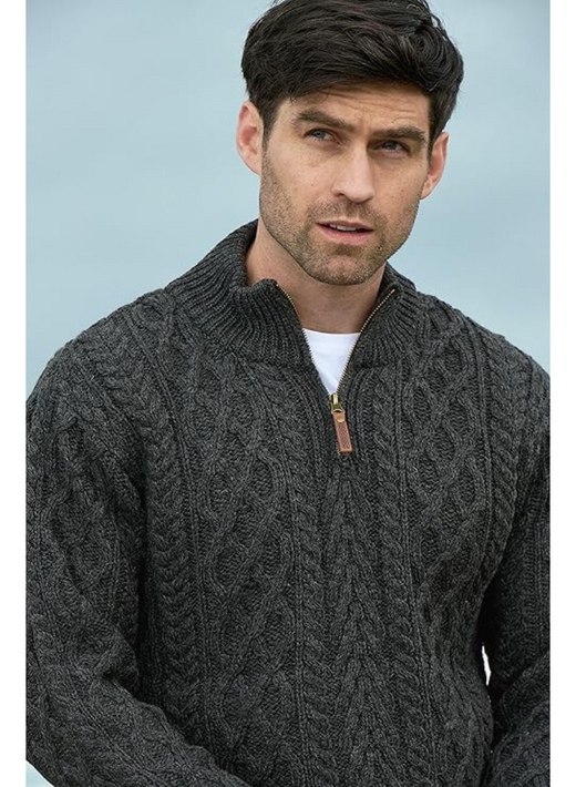 Male model wearing charcoal Aran half zip cable knit sweater.