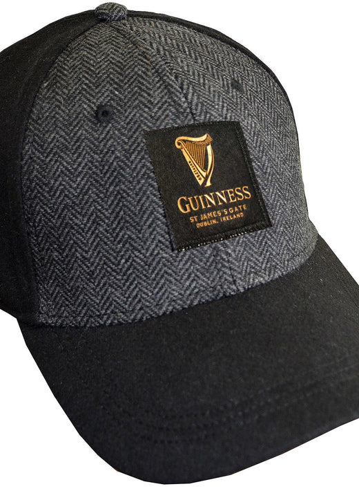 Black and gray baseball cap with a Guinness logo patch on front