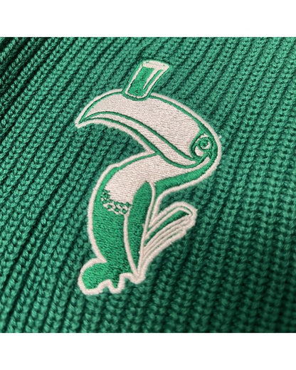 Close up of white and green embroidered crest on the knitted Guinness cardigan