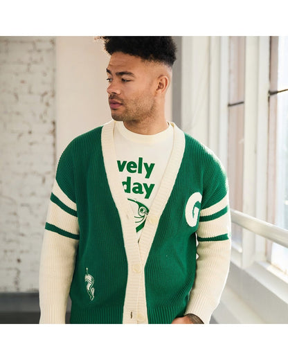 Male model wearing green and cream cardigan with white sleeves and Guinness Ireland lettering on the back
